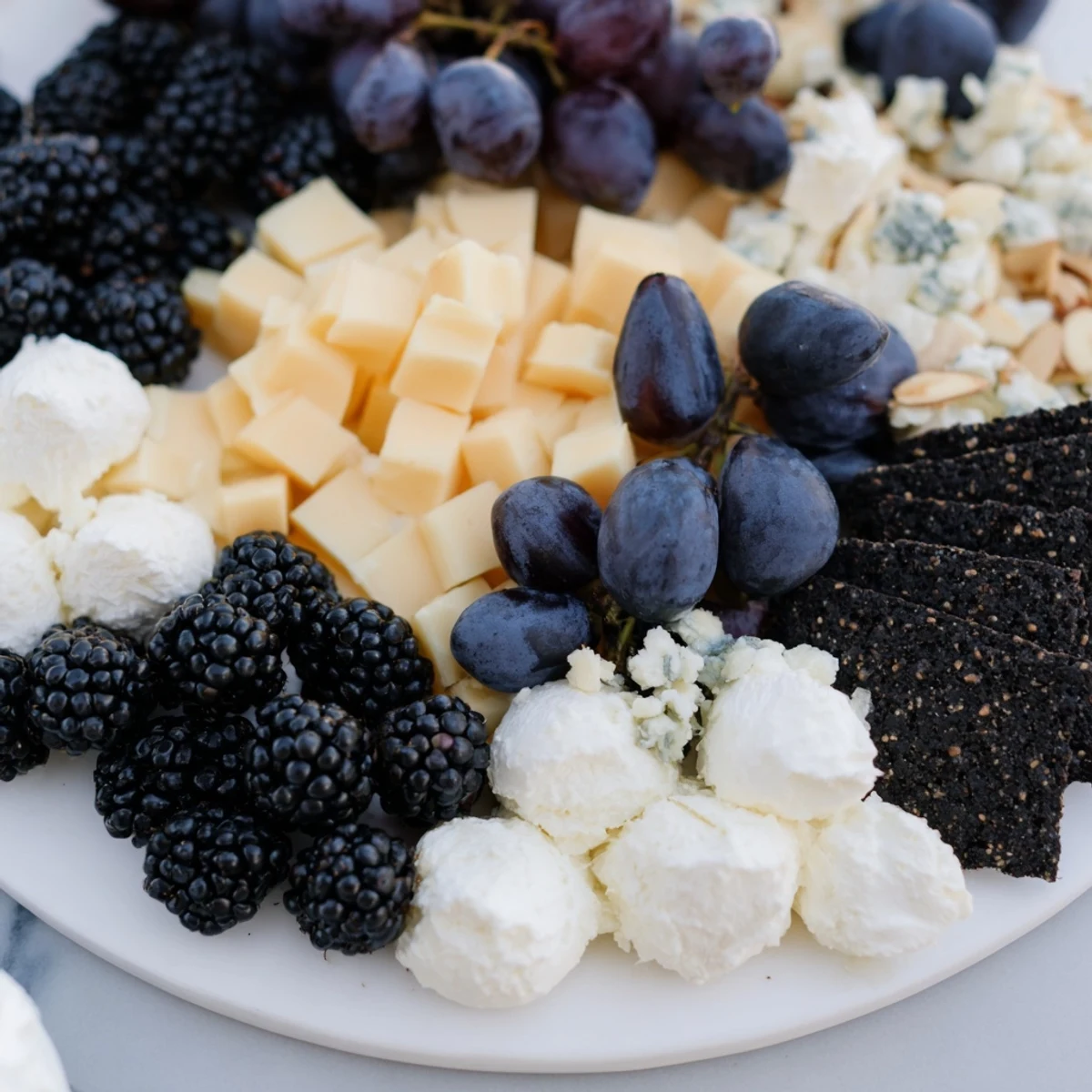 Deep Indigo Midnight Sky cheese board with blackberries and figs, a beautiful appetizer to serve.