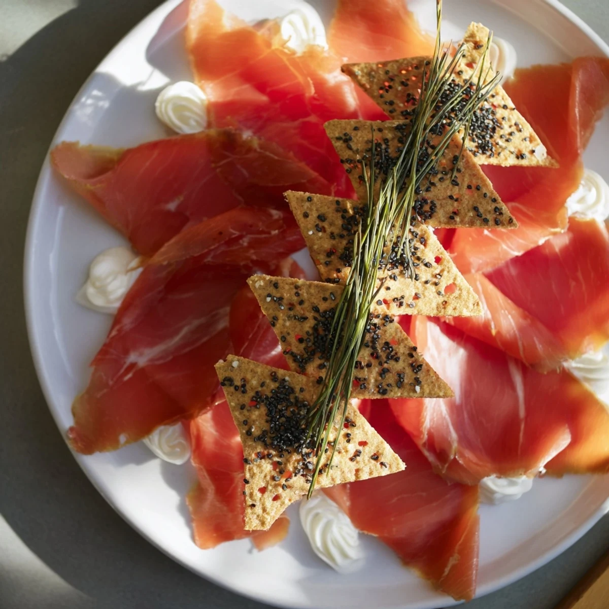 Artfully arranged Paper Crane appetizer, with prosciutto and sesame crackers, is visually striking and delicious.