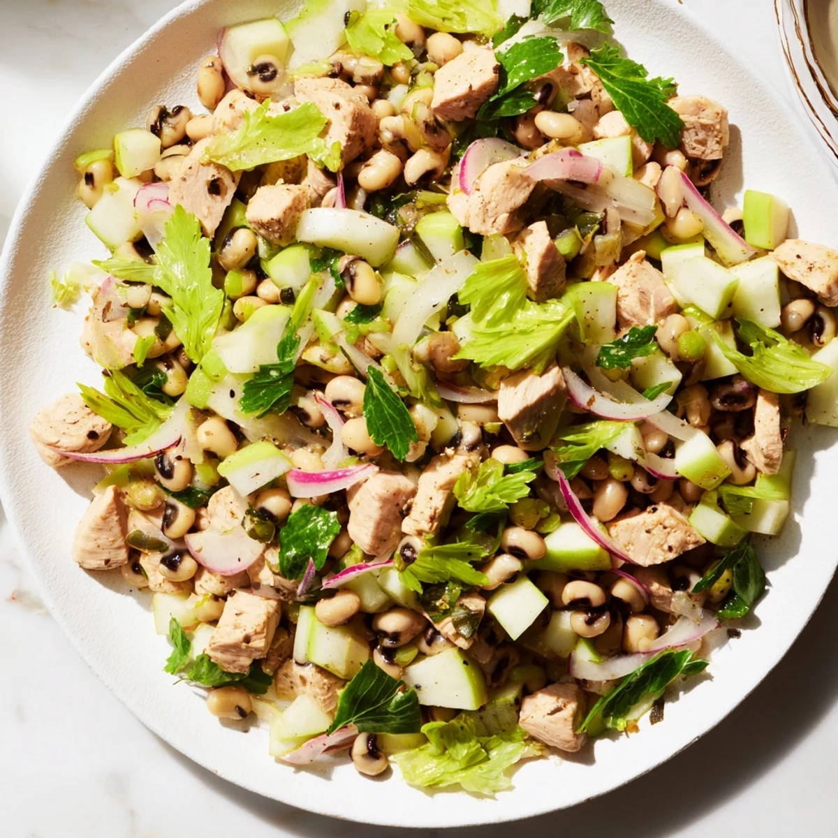 Flavorful Chicken and Apple New Years Luck Salad with crisp apples, black-eyed peas, and honey mustard dressing.