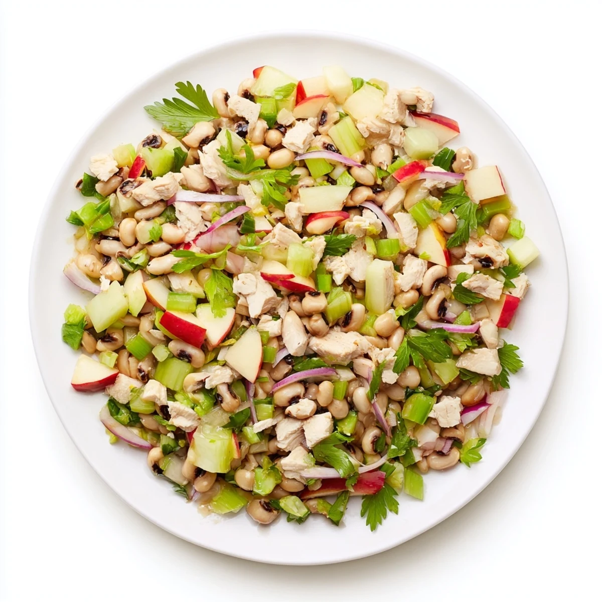 Tender chicken, black-eyed peas, and apple salad in a bowl: a lucky Chicken and Apple New Years Luck Salad.