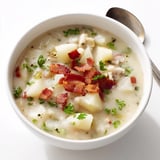 A bowl of homemade New England Clam Chowder, garnished with parsley, looks warm and comforting.