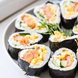 A close-up of a beautifully arranged High-Protein Sushi Wrap Smoked Salmon Holiday Roll, ready to eat.