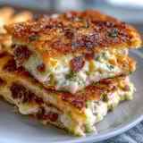 Crispy cheese straws with Parmesan and cayenne, baked to golden perfection for a spicy, savory snack.