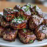 Juicy steak cubes seared to golden brown perfection with garlic butter and fresh herbs.  