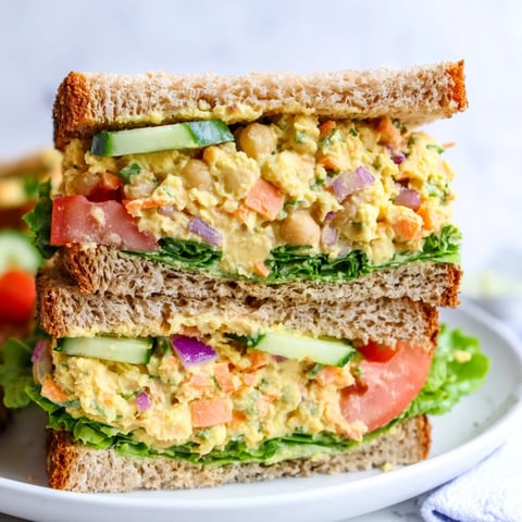 Freshly made easy chickpea salad sandwich, bursting with colorful vegetables ready to eat.
