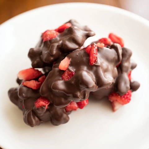 Creamy Strawberry Yogurt Clusters, frozen solid, with glistening chocolate coating ready to eat.