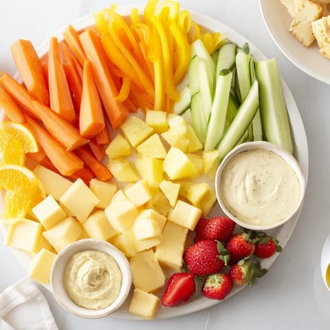 Sunshine Snack Tray bursting with vibrant fruits, crisp veggies, and creamy cheeses for sharing.