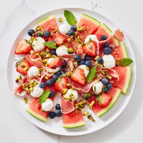 Vibrant Watermelon Slice Charcuterie featuring juicy watermelon, berries, and crumbled feta cheese, perfect for summer!