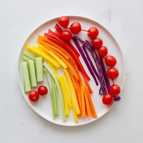 Vibrant Rainbow Arch Bright Veggie Sticks: Colorful bell peppers, carrots, and cucumbers presented as a refreshing appetizer.