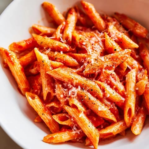 Steaming al dente fusilli tossed with butter, fresh pepper, and a spoon of vibrant pesto.  