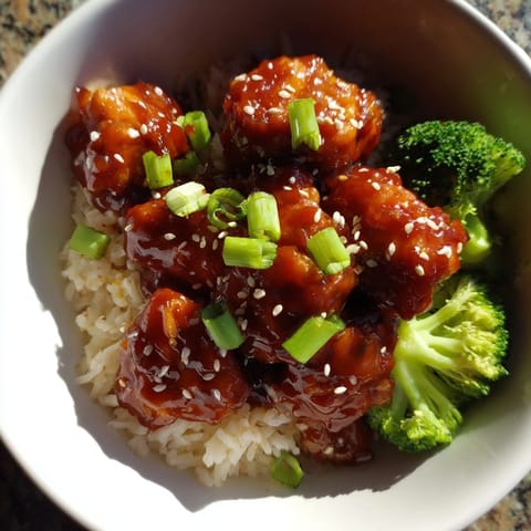 A serving bowl of sweet chili chicken, steamed rice, and crisp broccoli, ready to enjoy for an easy weeknight dinner.
