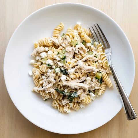 Tender shredded chicken and bright cilantro-lime yogurt sauce toss with rotini pasta for a fresh, zesty dinner.