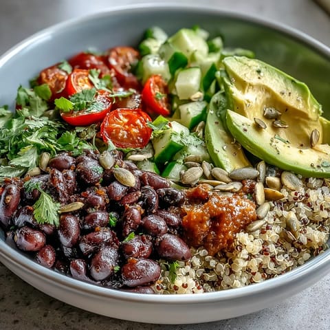 Hearty Three-Bean Power Bowl featuring crisp bell peppers and cherry tomatoes tossed in a zesty lemon dressing.