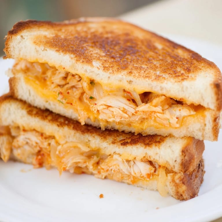 Sharp cheddar oozing from a perfectly toasted Kimchi Turkey & Cheddar Grilled Cheese sandwich.