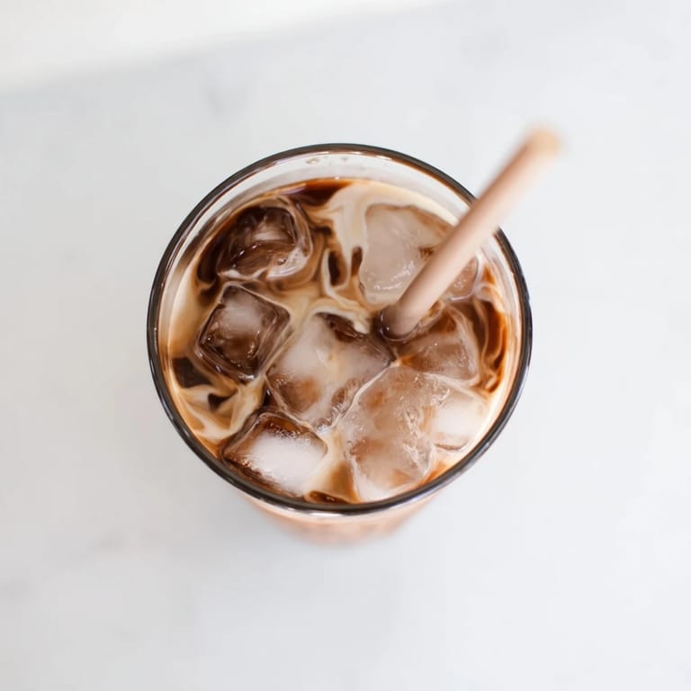 Chilled chocolatey Milo Ice Latte Hack in a clear glass, creamy texture, ready to enjoy on a warm afternoon.