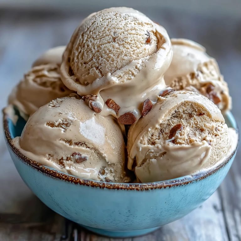 Churned Hojicha ice cream in a freezer container, showcasing its smooth, roasted green tea texture.