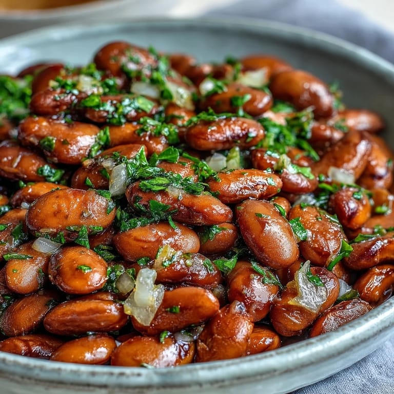 Tender, creamy pinto beans ready for taco filling or chili base, garnished with fresh cilantro.