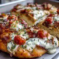 Kentucky Derby Hot Brown Flatbread Pizza with golden crust, creamy Mornay sauce, roasted turkey, bacon, tomatoes, and melted cheese.